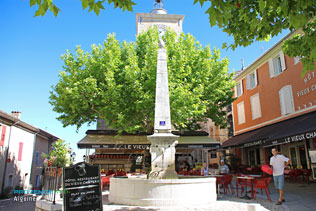 Aiguines, the fountain and its cafe terraces